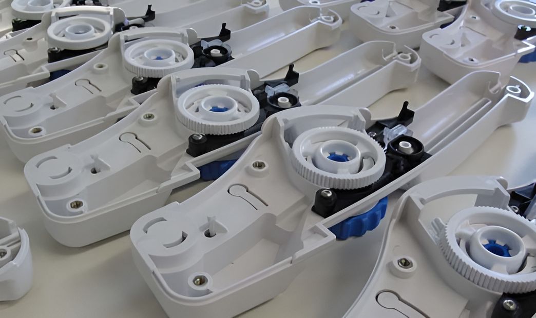 Picture of a set of white molded parts in a disasebled state.